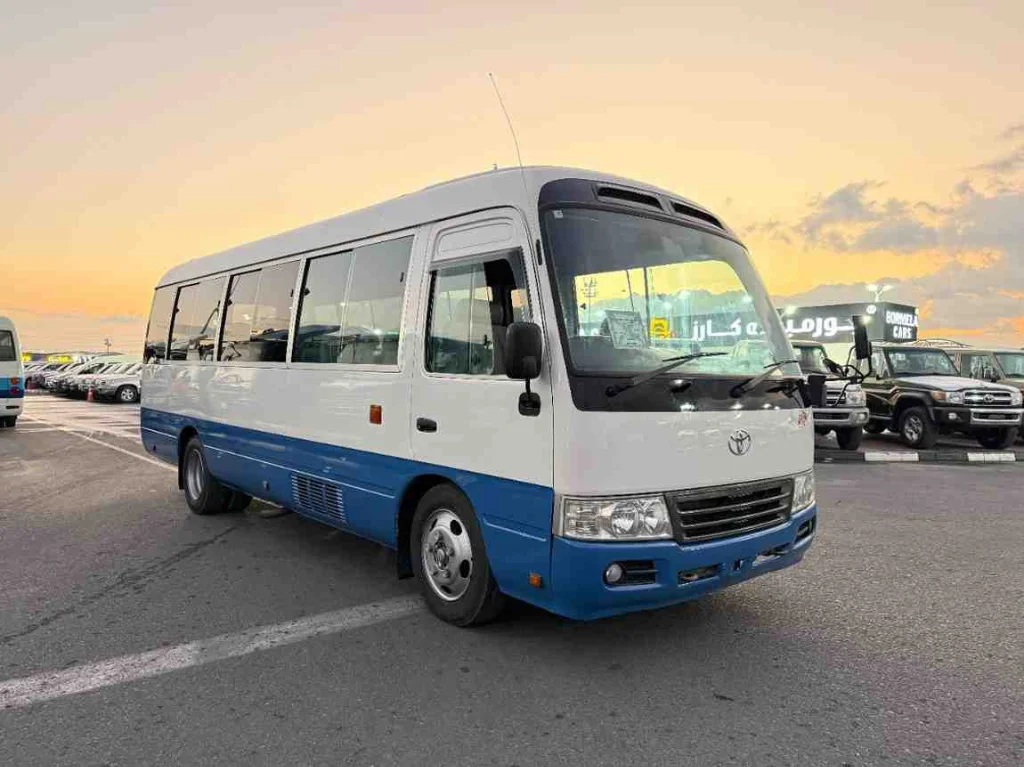 White Toyota Coaster — Commercial Vehicle Rental for Large Groups